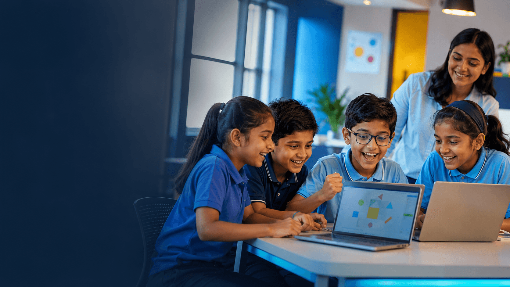 Happy Indian schoolchildren learning computers together